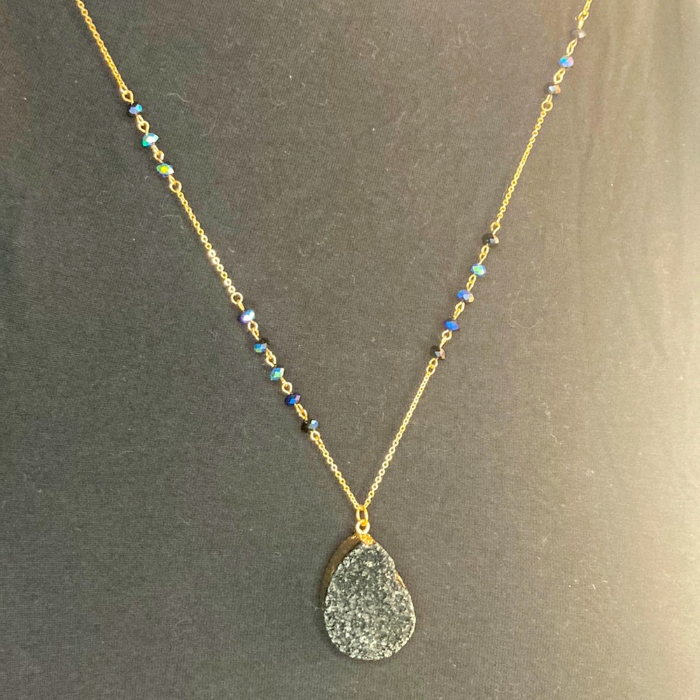 Gold chain necklace with blue black and green beads with hanging cut obsidian